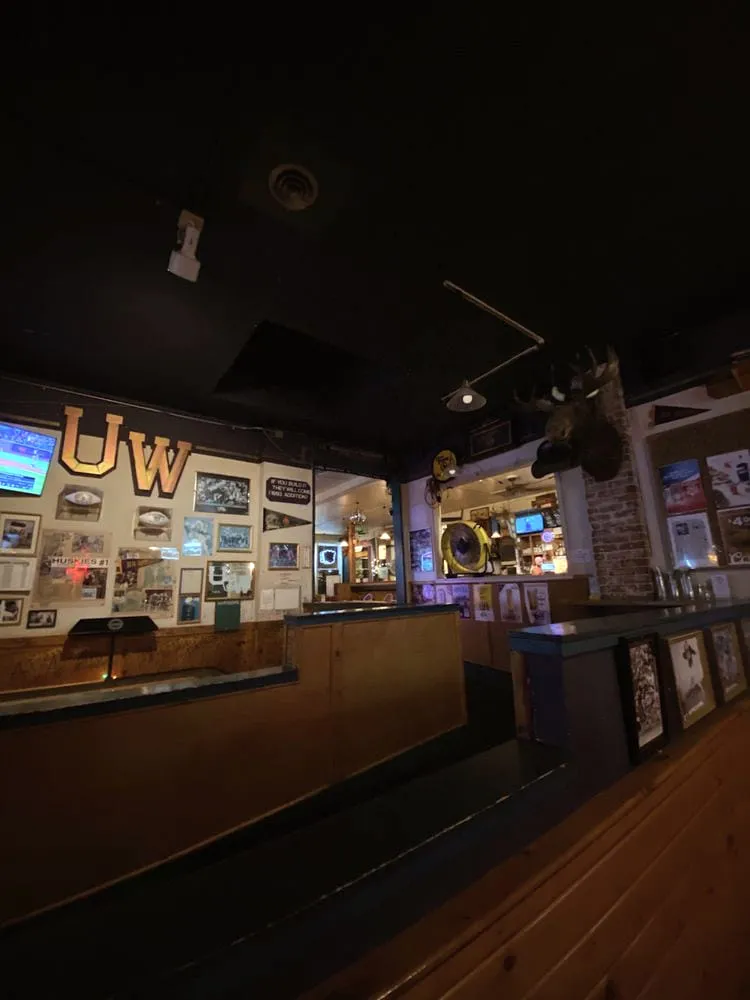 The shuffleboard table under the UW letters and a mounted moose at the Duchess Tavern